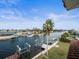 Waterfront backyard with a dock, boat lift and scenic views of the water and neighborhood at 3447 Flamingo Blvd, Hernando Beach, FL 34607