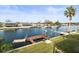 Waterfront backyard featuring a private dock, boat lift, and lush green lawn at 3447 Flamingo Blvd, Hernando Beach, FL 34607