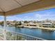 Balcony view overlooking the serene waterfront and neighborhood homes at 3447 Flamingo Blvd, Hernando Beach, FL 34607