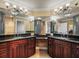 Bathroom featuring double sinks, granite countertops and large mirrors at 3447 Flamingo Blvd, Hernando Beach, FL 34607