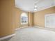A spacious bedroom with plush carpeting, neutral paint, and light-filled windows at 3447 Flamingo Blvd, Hernando Beach, FL 34607