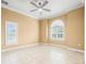 Bedroom with neutral color palette, decorative ceiling fan, and tiled floor at 3447 Flamingo Blvd, Hernando Beach, FL 34607