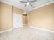Bedroom with neutral color palette, decorative ceiling fan, and tiled floor at 3447 Flamingo Blvd, Hernando Beach, FL 34607