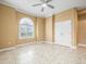 Bedroom with neutral color palette, decorative ceiling fan, and tiled floor at 3447 Flamingo Blvd, Hernando Beach, FL 34607