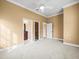 A bright bedroom features fresh paint, neutral carpet, and two doorways to adjoining rooms at 3447 Flamingo Blvd, Hernando Beach, FL 34607