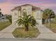 Elegant home with a tile roof, arched windows, and a manicured lawn at 3447 Flamingo Blvd, Hernando Beach, FL 34607