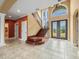 Elegant foyer featuring a staircase, chandelier, and tile flooring leading to a stunning entryway at 3447 Flamingo Blvd, Hernando Beach, FL 34607