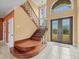 Grand foyer with a staircase, a chandelier, and a view of the front yard at 3447 Flamingo Blvd, Hernando Beach, FL 34607