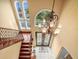 Grand foyer with a high ceiling, statement chandelier, and elegant staircase with wrought iron railing at 3447 Flamingo Blvd, Hernando Beach, FL 34607