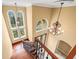 Foyer with staircase, chandelier, and arched windows, offering an inviting entrance to the home at 3447 Flamingo Blvd, Hernando Beach, FL 34607