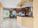 Cherry cabinets, stainless steel appliances, and granite countertops complete the kitchen area at 3447 Flamingo Blvd, Hernando Beach, FL 34607