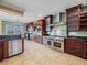 Spacious kitchen featuring stainless steel appliances, custom cabinets, and tile flooring at 3447 Flamingo Blvd, Hernando Beach, FL 34607
