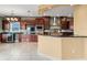 Open-concept kitchen with cherry cabinets, stainless steel appliances, and a center island at 3447 Flamingo Blvd, Hernando Beach, FL 34607