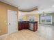 Kitchenette features custom cabinets, a stainless steel dishwasher, tile floor, and granite countertops at 3447 Flamingo Blvd, Hernando Beach, FL 34607