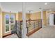 Second floor landing with decorative columns and wrought iron railing overlooking the foyer at 3447 Flamingo Blvd, Hernando Beach, FL 34607