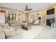 Bright and airy living room with neutral decor, tile flooring, and a cozy fireplace at 3447 Flamingo Blvd, Hernando Beach, FL 34607
