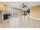 Bright living room with fireplace, ceiling fan, and french doors leading to outdoor space at 3447 Flamingo Blvd, Hernando Beach, FL 34607