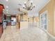 Spacious living room with ceramic tile floor, a chandelier, and access to the kitchen and balcony at 3447 Flamingo Blvd, Hernando Beach, FL 34607