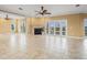 Expansive living room featuring a fireplace, tile floors, and access to balconies offering waterfront views at 3447 Flamingo Blvd, Hernando Beach, FL 34607