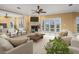 Spacious living room with a fireplace, a ceiling fan, and a view of the water at 3447 Flamingo Blvd, Hernando Beach, FL 34607