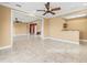 Expansive living room featuring tile floors, a ceiling fan, and an open layout for entertaining guests at 3447 Flamingo Blvd, Hernando Beach, FL 34607