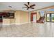 Open-concept living space with tile floors, a bar top, and an adjacent staircase to the upper level at 3447 Flamingo Blvd, Hernando Beach, FL 34607