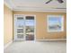 Spacious main bedroom features a balcony access, large windows, and neutral carpet at 3447 Flamingo Blvd, Hernando Beach, FL 34607