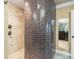 Walk-in shower featuring tile surround, mosaic tile accent, and glass enclosure at 3447 Flamingo Blvd, Hernando Beach, FL 34607