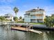Stunning three-story waterfront home featuring private dock and balconies overlooking the channel at 3447 Flamingo Blvd, Hernando Beach, FL 34607