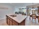 Kitchen island with stainless steel sink adjacent to the living room at 36707 Goffaux Loop, Zephyrhills, FL 33541