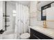 Modern bathroom featuring marble tile, gold fixtures, and sleek vanity at 3765 21St S Ave, St Petersburg, FL 33711