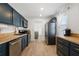 Stylish kitchen with stainless steel appliances, wood countertops, and dark blue cabinetry at 3765 21St S Ave, St Petersburg, FL 33711