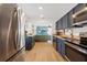 Open kitchen with stainless steel appliances and views to living room at 3765 21St S Ave, St Petersburg, FL 33711
