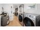 Laundry area with washer, dryer, water heater, and view to kitchen at 3765 21St S Ave, St Petersburg, FL 33711
