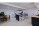 Open kitchen featuring white cabinetry, dark countertops, and barstool seating at the island at 3908 Wahoo Se Dr, St Petersburg, FL 33705