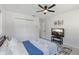 Comfortable bedroom with a ceiling fan and a mounted television for relaxation at 4149 38Th S St, St Petersburg, FL 33711