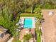 Aerial view of a community pool surrounded by lush greenery and well-maintained landscaping at 4216 Preserve Pl, Palm Harbor, FL 34685