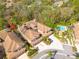 Aerial shot of the townhome showing the pool and surrounding mature trees at 4216 Preserve Pl, Palm Harbor, FL 34685