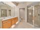 Bathroom featuring a double sink vanity and a glass-enclosed walk-in shower at 4216 Preserve Pl, Palm Harbor, FL 34685