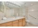 Bright bathroom with a long vanity, large mirror, and tub-shower combo at 4216 Preserve Pl, Palm Harbor, FL 34685