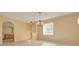 Well-lit dining room with neutral walls and a view of the kitchen and breakfast nook at 4216 Preserve Pl, Palm Harbor, FL 34685