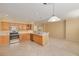 Spacious kitchen with stainless appliances, light wood cabinetry, breakfast bar, and tile flooring at 4216 Preserve Pl, Palm Harbor, FL 34685