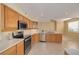 Modern kitchen with stainless steel appliances, ample counter space, and tile flooring at 4216 Preserve Pl, Palm Harbor, FL 34685