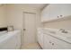 Bright laundry room with white cabinets, sink, and washer/dryer hookups at 4216 Preserve Pl, Palm Harbor, FL 34685