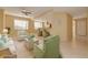 Open living area with view into kitchen, light-colored walls, tile and carpet flooring, and lots of natural light at 4216 Preserve Pl, Palm Harbor, FL 34685