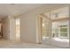 Open living room boasts natural light with direct access to a screened in patio at 4216 Preserve Pl, Palm Harbor, FL 34685