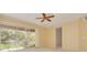 Spacious main bedroom featuring sliding glass doors to the lanai and a ceiling fan at 4216 Preserve Pl, Palm Harbor, FL 34685