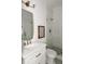 Modern bathroom showcasing a glass shower, white vanity, and stylish gold fixtures at 440 Capri Ne Way, St Petersburg, FL 33704