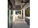 Beautiful covered patio with tile flooring, ceiling fans, and black metal railing overlooking the neighborhood at 440 Capri Ne Way, St Petersburg, FL 33704