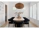 Elegant dining room with contemporary chandelier, seating for eight, and bright natural light at 440 Capri Ne Way, St Petersburg, FL 33704